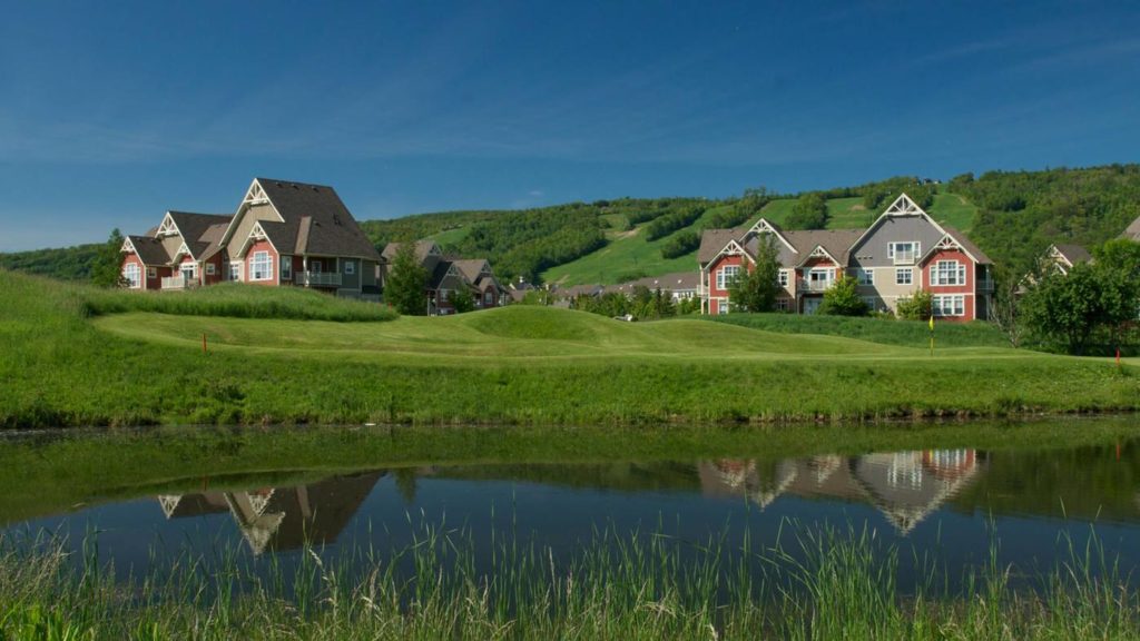 Blue Mountain Village resorts and golf course with ski hills in background during the summer months
